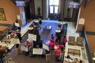 Supporters of stricter abortion laws and opponents watch the South Carolina House special session on abortion on monitors in the Statehouse lobby on Tuesday, Sept. 27, 2022, in Columbia, S.C. (AP Photo/Jeffrey Collins)