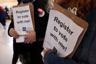 Volunteers stand by to register voters during the Women's March rally in Las Vegas, Nevada, U.S. January 21, 2018. REUTERS/Steve Marcus