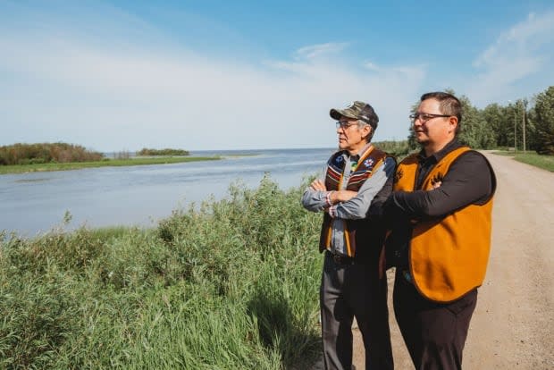 Dene National Chief Norman Yakeleya with Kenny Cayen, grand chief of Dehcho First Nations at the West Point First Nation Treaty 11 celebrations earlier this month. This summer, people across the N.W.T. are marking 100 years since the treaty was signed.  (Nicole Wang for CBC North - image credit)