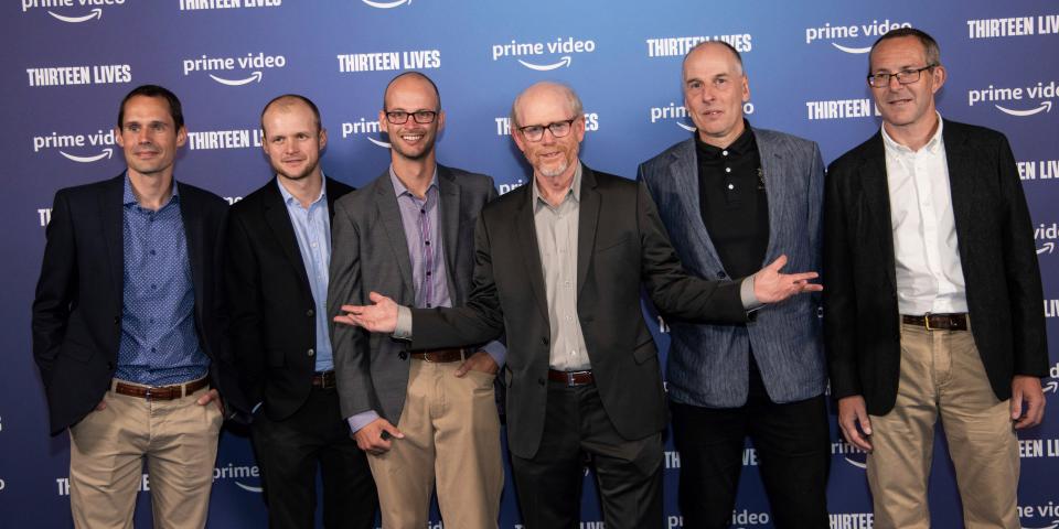 Director Ron Howard stands with several divers, including John Volanthen at the "Thirteen Lives" premiere.