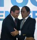 Social Democratic Party leader and Prime Minister, Pedro Passos Coelho (L), and coalition leader of the Popular Party, Paulo Portas, congratulate each other in Lisbon after winning the general elections, on October 4, 2015