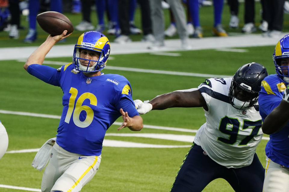 Los Angeles Rams quarterback Jared Goff (16) throws under pressure from Seattle Seahawks defensive tackle Poona Ford (97) during the first half of an NFL football game Sunday, Nov. 15, 2020, in Inglewood, Calif. (AP Photo/Ashley Landis)