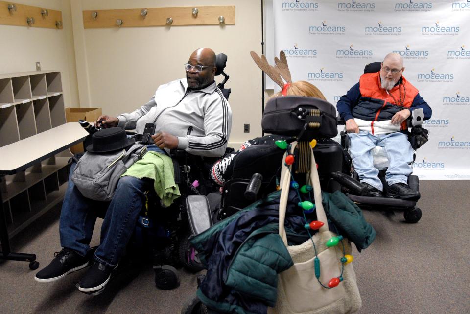 Wali Mohammed, left, Amanda Chirelli and Stanley Soden on Tuesday, December 13, 2022 at the office of MOCEANS Center for Independent Living located in Brookdale Community College in Long Branch, New Jersey. Mohammed, Chirelli and Soden work at MOCEANS, which operates as a free resource for people with disabilities to connect them with transportation, housing and employment training.