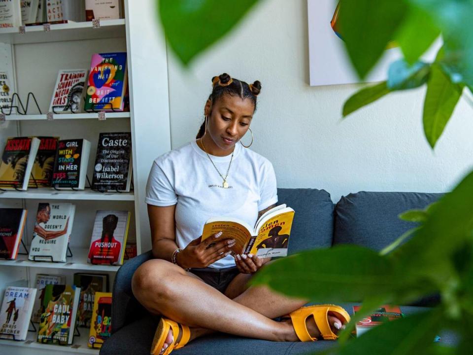 Cori Smith sits in her new bookstore BLK + BRWN, Friday, June 18, 2021, in Kansas City, Mo.