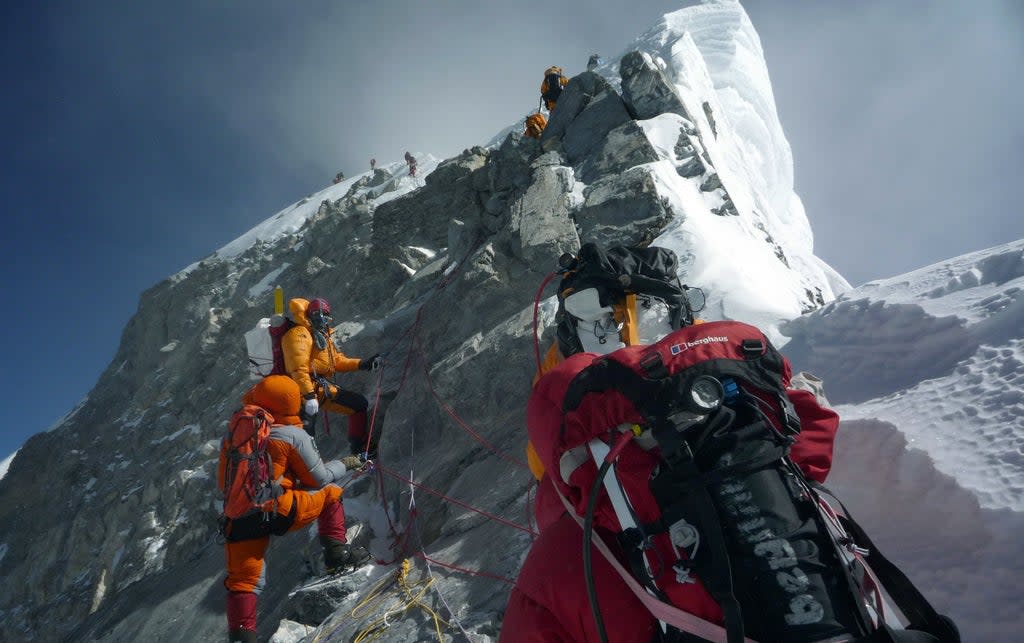 Mountaineers head past the Hillary Step on the way to the summit of Everest during a high-risk attempt  (AFP/Getty)