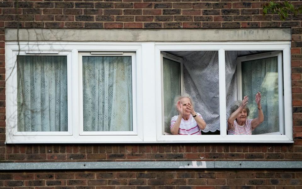 Residents in nearby houses outside Whittington Hospital in London joining in the applause - Aaron Chown/PA Wire