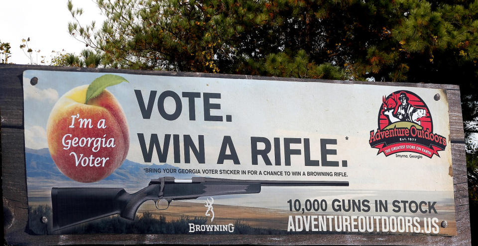 One of several billboards of a gun raffle promotion at Adventures Outdoors in Smyrna.