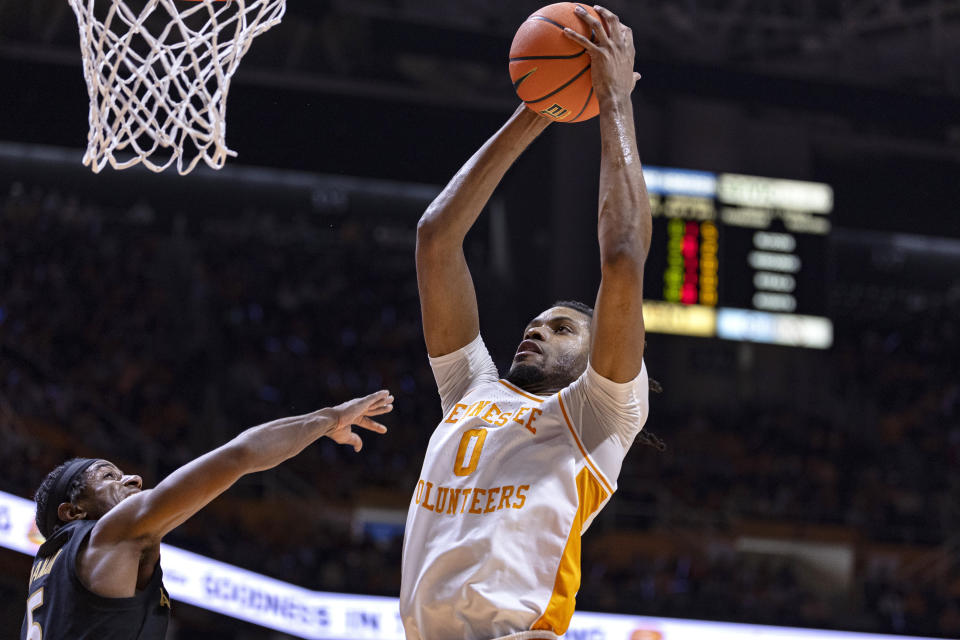 Tennessee forward Jonas Aidoo (0) goes for a dunk past Vanderbilt guard Ezra Manjon (5) during the first half of an NCAA college basketball game Saturday, Feb. 17, 2024, in Knoxville, Tenn. (AP Photo/Wade Payne)