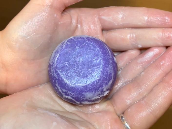 A shampoo bar lathered up with bubbles.