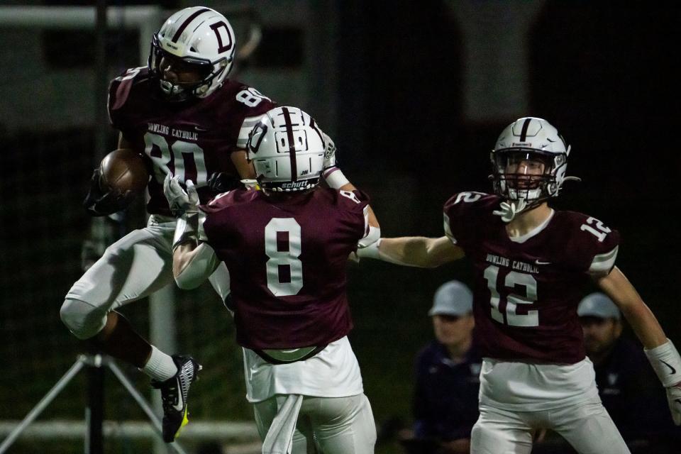 Dowling Catholic's Hank Brown celebrates scoring a touchdown during Friday’s game against Waukee.