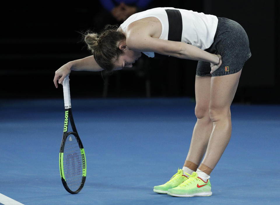 Romania's Simona Halep rests on her racket after losing a point to United States' Sofia Kenin during their second round match at the Australian Open tennis championships in Melbourne, Australia, Thursday, Jan. 17, 2019. (AP Photo/Aaron Favila)