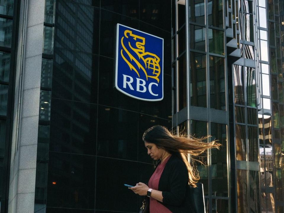  A woman passes Royal Bank of Canada signage in Toronto’s financial district.