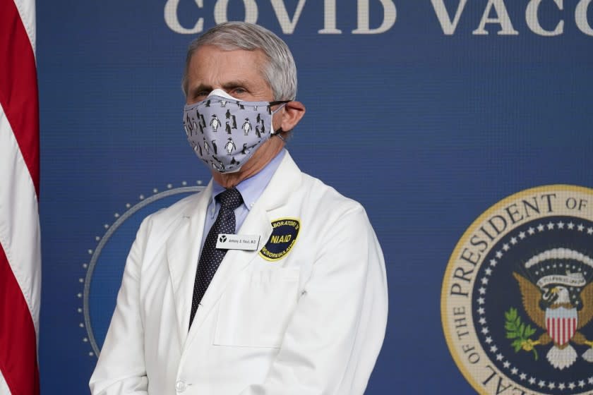 FILE - In this Feb. 25, 2021, Dr. Anthony Fauci, director of the National Institute of Allergy and Infectious Diseases, listens as President Joe Biden speaks during an event to commemorate the 50 millionth COVID-19 shot in Washington. Fauci said Sunday, March 14, he wishes former President Donald Trump would use his popularity among Republicans to persuade his followers to get the COVID-19 vaccine. In a round of interviews on the morning news shows, Fauci lamented polling showing that Trump supporters are more likely to refuse to get vaccinated, saying politics needs to be separated from "commonsense, no-brainer" public health measures. (AP Photo/Evan Vucci, File)