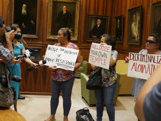 Protesters outside a news conference about the construction of the telescope, 10 July 2019 (AP)