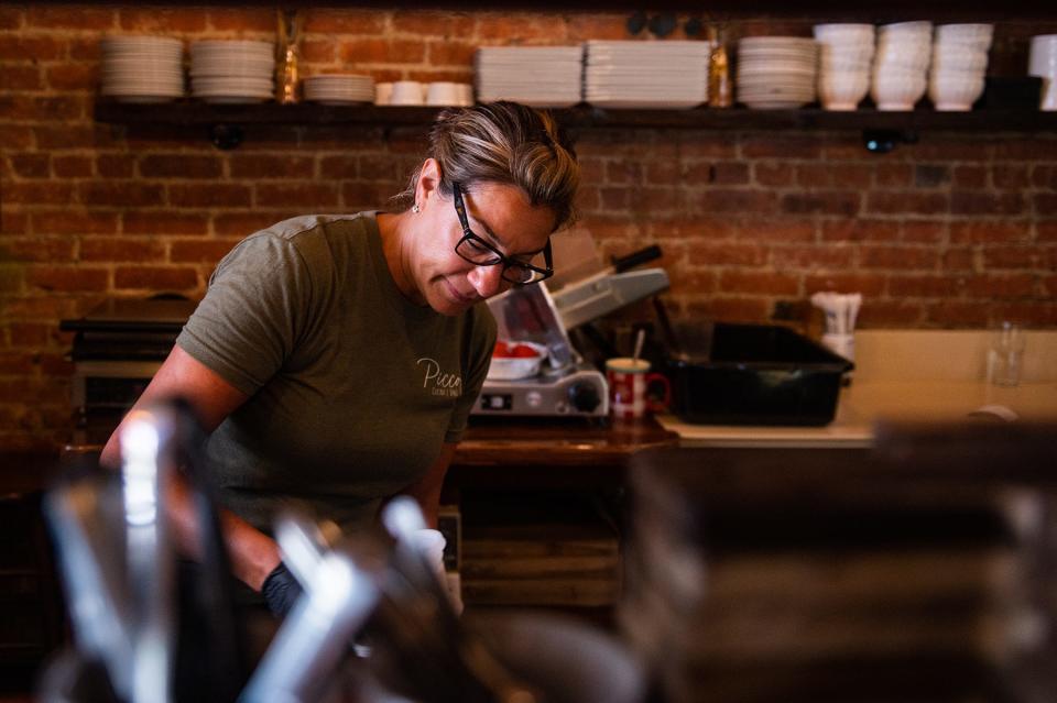 Anna Madden, owner of Piccolo Cucina e Vino, prepares an order for customers at the restaurant in Middletown on Tuesday, June 28.