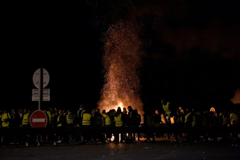 "Yellow vest" protesters stand around a fire in Virsac, near Bordeaux, southwestern France, on Sunday night