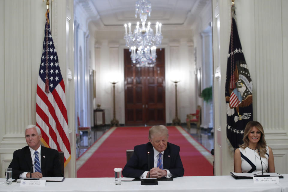 President Donald Trump, Vice President Mike Pence, left, and first lady Melania Trump, attend a "National Dialogue on Safely Reopening America's Schools," event in the East Room of the White House, Tuesday, July 7, 2020, in Washington. (AP Photo/Alex Brandon)