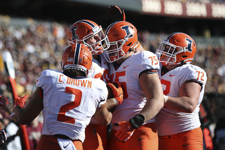 Illinois tight end Tip Reiman (89), second from left, celebrates with teammates after scoring a touchdown against Minnesota, during an NCAA college football game Saturday, Nov. 6, 2021, in Minneapolis. (AP Photo/Stacy Bengs)