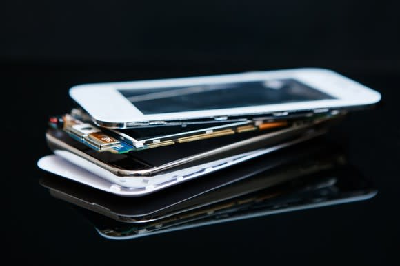 A stack of broken smartphones.