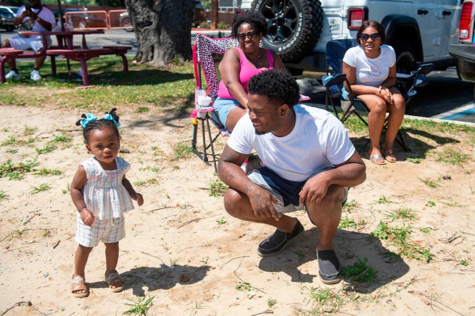 E’niyrie Ricard, 1, of Louisiana poses with her family during during Black Spring Break in Biloxi on Saturday, April 13, 2024.