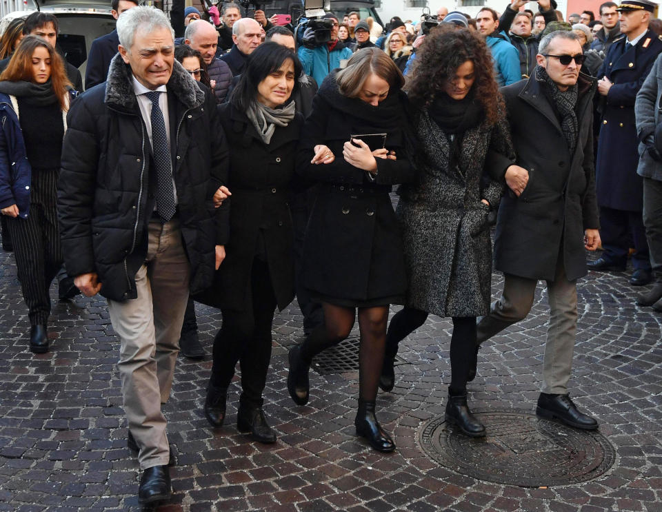 From left, Antonio's father, Antonio's mother, Antonio's girlfriend and Antonio's sister arrive at Trento's Duomo for the funeral of Antonio Megalizzi, the Italian reporter killed during a terrorist attack in Strasbourg, Thursday, Dec. 20, 2018. Megalizzi and four other people died and several others were injured in a terror attack on Dec. 11 at a Christmas Market in Strasbourg, France. (Daniel Dal Zennaro/ANSA via AP)
