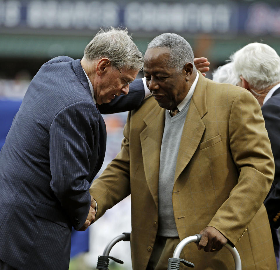 Commissioner of Major League Baseball Bud Selig, left, talks with Hank Aaron during a ceremony celebrating the 40th anniversary of Aaron's 715th home run before the start of a baseball game between the Atlanta Braves and the New York Mets, Tuesday, April 8, 2014, in Atlanta. (AP Photo/David Goldman)