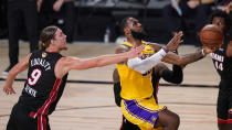 Los Angeles Lakers' LeBron James, right, drives to the basket past Miami Heat's Kelly Olynyk (9) during the second half of Game 1 of basketball's NBA Finals Wednesday, Sept. 30, 2020, in Lake Buena Vista, Fla. (AP Photo/Mark J. Terrill)