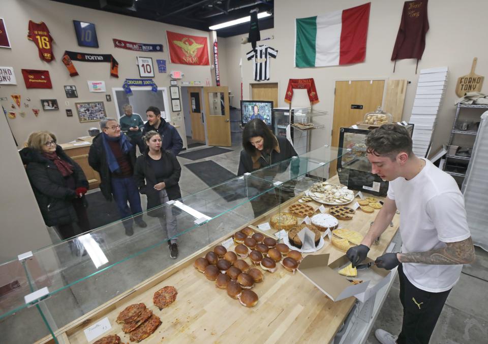 Ryan Gushue fills customers orders at the newly opened Forno Tony.