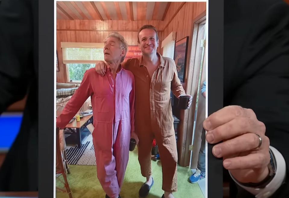 Stephen Colbert shows a photo of Harrison Ford and Jason Segel wearing jumpsuits together behind the scenes of "Shrinking"