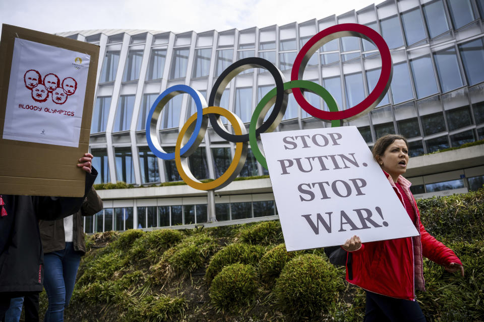 Members of the Geneva branch of Ukrainian society in Switzerland protest during a rally to urge International Olympic Committee to reconsider their decision of participation of Russian and Belarusian athletes under white neutral flag at the next 2024 Paris Olympic Games, in front of the IOC headquarters, in Lausanne, Switzerland, Saturday, March 25, 2023. (Jean-Christophe Bott/Keystone via AP)