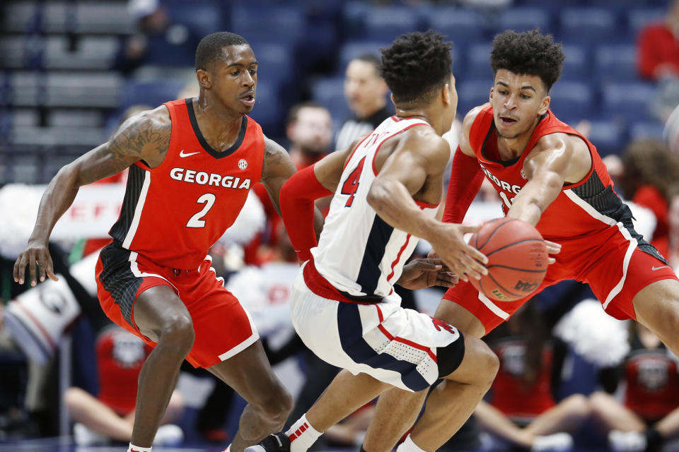 Georgia's Jordan Harris (2) and Toumani Camara, right, block the path of Mississippi's Breein Tyree (4) in the first half of an NCAA college basketball game in the Southeastern Conference Tournament Wednesday, March 11, 2020, in Nashville, Tenn. (AP Photo/Mark Humphrey)