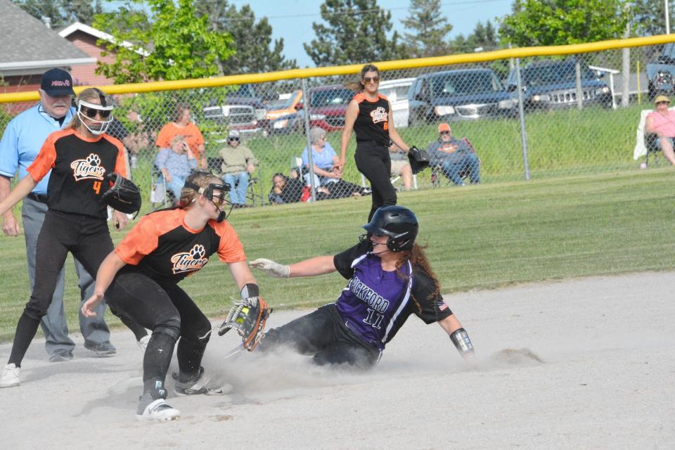 Chloe May of Pickford (11) slides safely into second base during a quarterfinal softball game against Hillman in Sault Ste. Marie Tuesday.