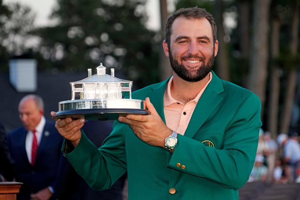 Scottie Scheffler poses with the winner's trophy after the final round of the Masters Tournament on April 14, 2024.
