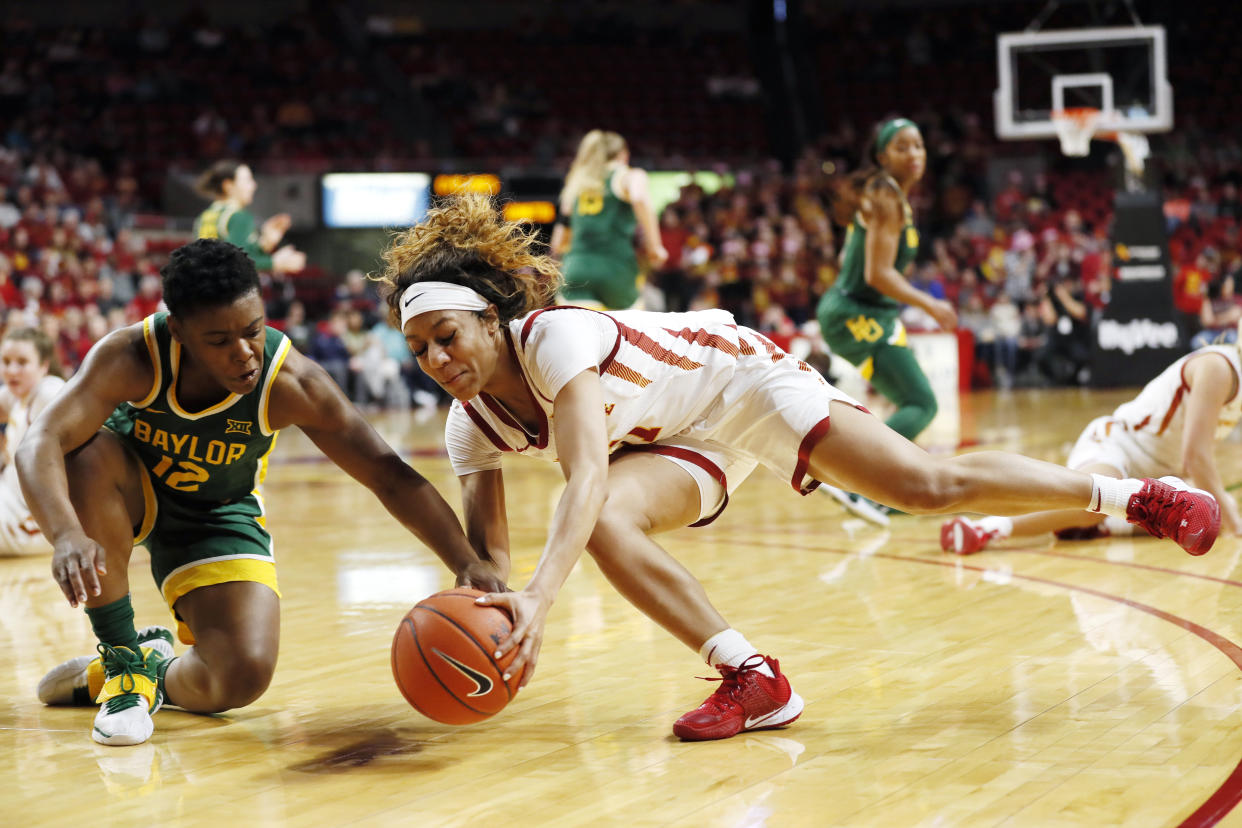 Baylor guard Moon Ursin, left, fights for the ball with Iowa State guard Jade Thurmon during the first half of an NCAA college basketball game, Sunday, March 8, 2020, in Ames, Iowa. (AP Photo/Charlie Neibergall)