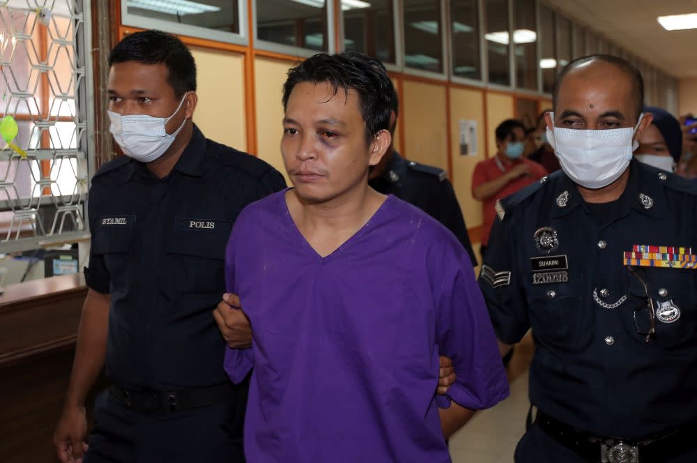 Lorry driver Muhammad Lokman Mohammad Termizi, 29, is escorted by police at the Kuala Kangsar Magistrate’s Court June 2, 2020. — Picture by Farhan Najib