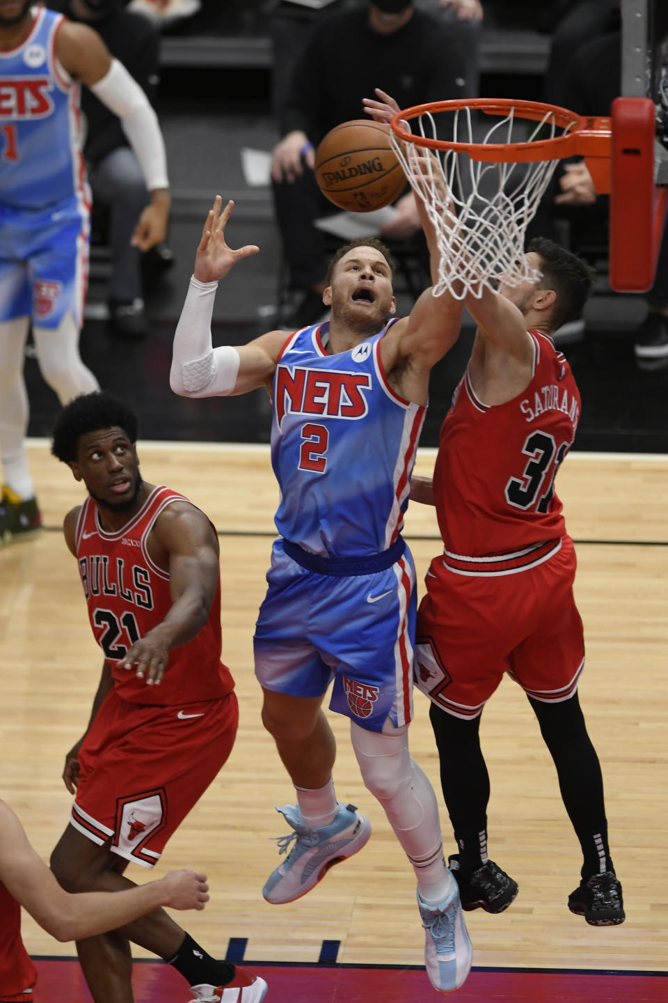 Brooklyn Nets' Blake Griffin (2) goes up for a rebound against Chicago Bulls' Thaddeus Young (21) and Tomas Satoransky (31) of The Czech Republic during the second half of an NBA basketball game Sunday, April 4, 2021, in Chicago. (AP Photo/Paul Beaty)