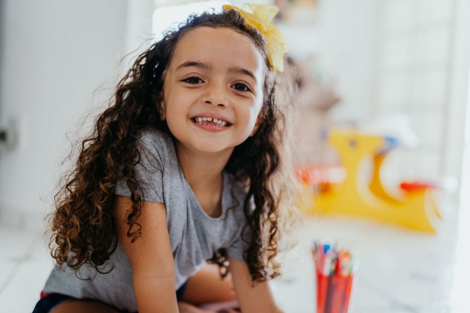 portrait of a smiling little girl at home