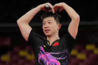 Ma Long of China makes a gesture after defeating Fan Zhendong of China during the gold medal match of the table tennis men's singles at the 2020 Summer Olympics, Friday, July 30, 2021, in Tokyo. (AP Photo/Kin Cheung)