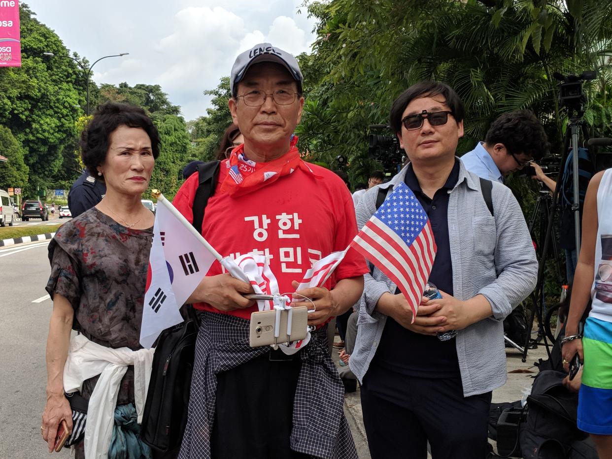 (Three of the four South Koreans who were involved in a protest near Capella on the day of the Trump-Kim summit on 12 June, 2018. They were later advised by the police to disperse. PHOTO: Wong Casandra/Yahoo News Singapore)