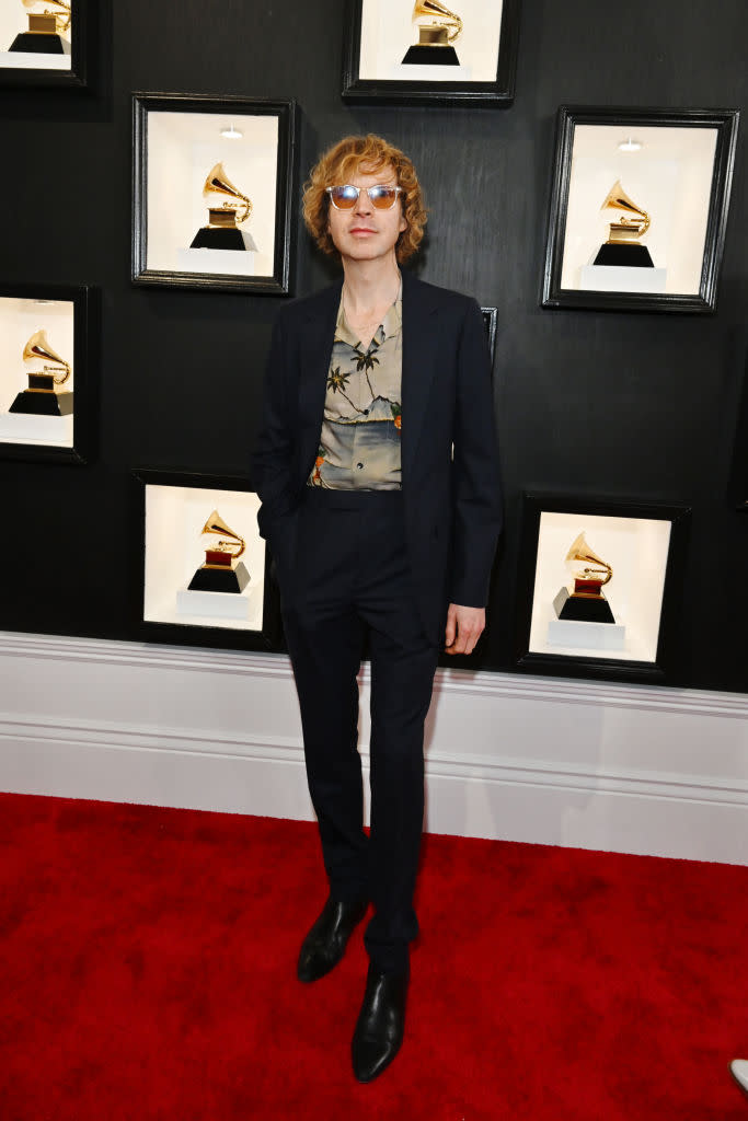 Beck in black suit with Hawaiian print shirt.