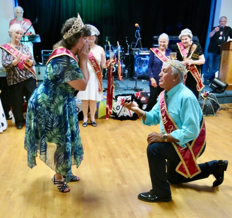 Doubly Special! Just-crowned Krewe of Elders XXVI Queen Sharon Davis receives a marriage proposal from Elders King XXVI Jesus Eguia at the Krewe's coronation event in August 2023.