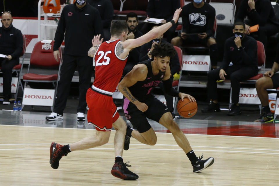 Penn State's Seth Lundy, right, drives the baseline past Ohio State's Kyle Young during the second half of an NCAA college basketball game Wednesday, Jan. 27, 2021, in Columbus, Ohio. Ohio State beat Penn State 83-79. (AP Photo/Jay LaPrete)