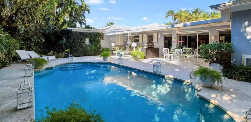 A 1951 house at 232 Mockingbird Trail, which just sold for a recorded $9.45 million, has a partially covered patio area facing the pool.