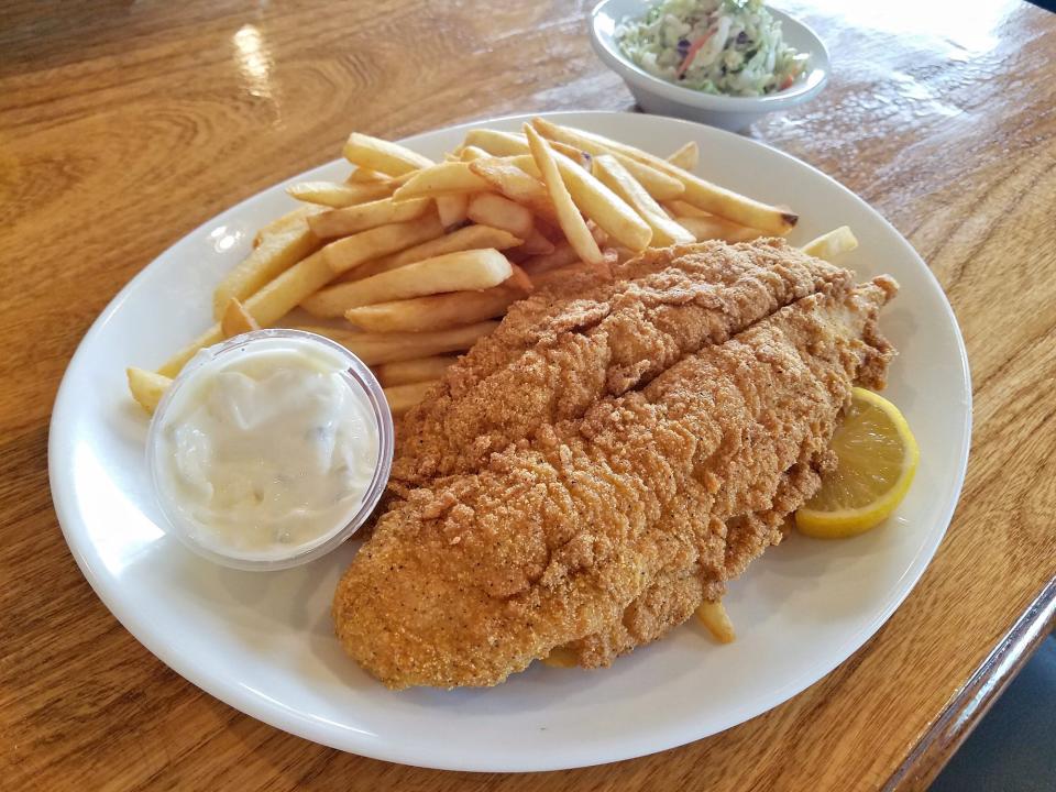 fried walleye with fries and tartar sauce on a plate