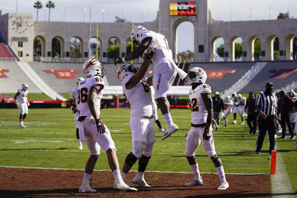 Arizona State running back Chip Trayanum (1) celebrates with teammates after scoring a touchdown against Southern California during the first half of an NCAA college football game is the phrase Saturday, Nov. 7, 2020, in Los Angeles. (AP Photo/Ashley Landis)