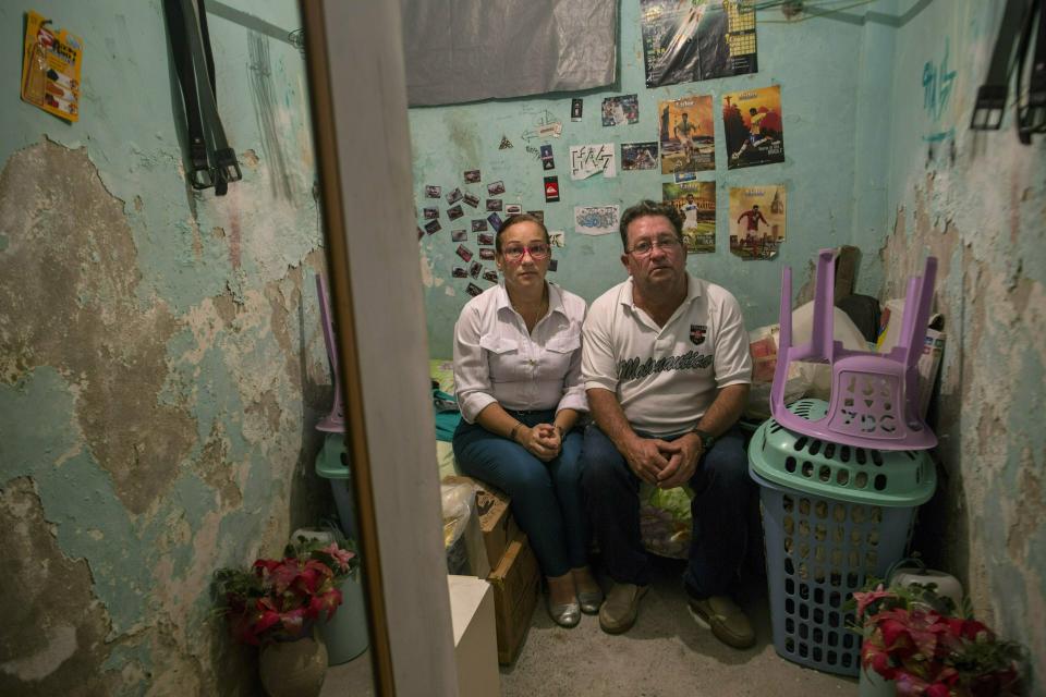 Ingrid Borjas and Pablo Borjas pose for a portrait inside the bedroom of their 19-year-old son Nick Samuel, who they say was killed when National Guards opened fire on anti-government protesters the previous week, in Caracas, Venezuela, Sunday, Feb. 3, 2019. "This needs to be investigated," Borjas said, her voice breaking with emotion. "Justice needs to be served for my son and for others." (AP Photo/Rodrigo Abd)