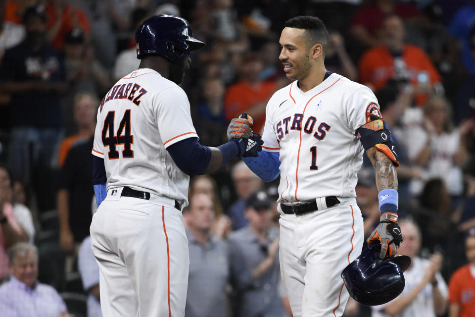 Houston Astros' Carlos Correa (1) celebrates his solo home run with Yordan Alvarez during the fourth inning of a baseball game against the Chicago White Sox, Sunday, June 20, 2021, in Houston. (AP Photo/Eric Christian Smith)