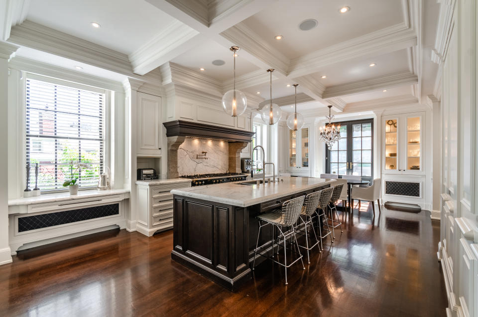 The kitchen features a grand centre island in marble. There's a <em>Lacanche Cote d'Or</em> 9-burner gas stove with double ovens, large Miele refrigerator, large Miele freezer, Miele dishwasher, compactor, double sink, garburator and pot filler.