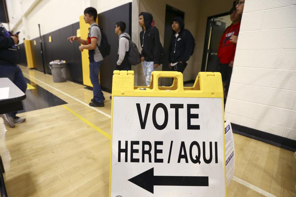 In this March 5, 2020, photo students line up to participate in their own Democratic presidential preference election and voter registration drive at Maryvale High School on in Phoenix. At the school hundreds of students who will turn 18 before Election Day were registered to vote. (AP Photo/Ross D. Franklin)