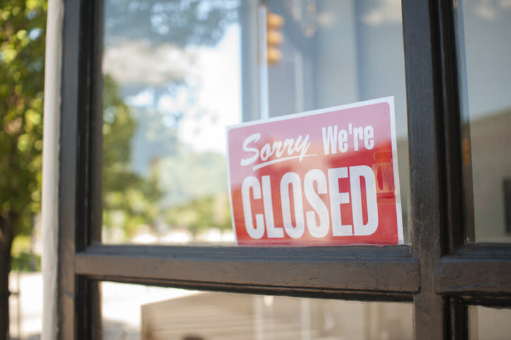 "sorry we're closed sign" in a window